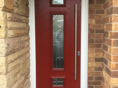 Contemporary red composite door with centre glass feature and an extra long handle for a Bispham customer.