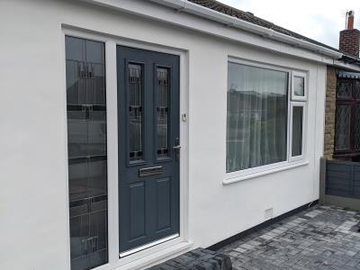 A rated uPVC double glazed windows and door frame done at the same time as rendering and new garden wall for Poulton home.