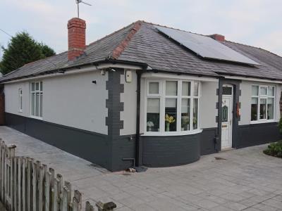 Removal of pebble dashing and re-render to a tyrolean finish in light grey wall coating with anthracite grey on the brickwork for a Preston home.